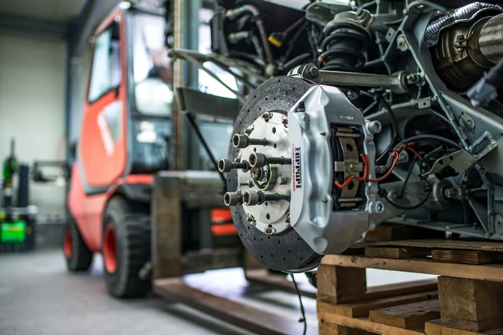 auto parts on a pallet being moved by forklift