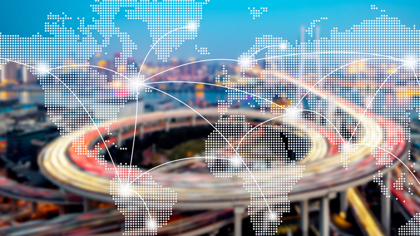 Aerial view of shipping port superimposed over world map.