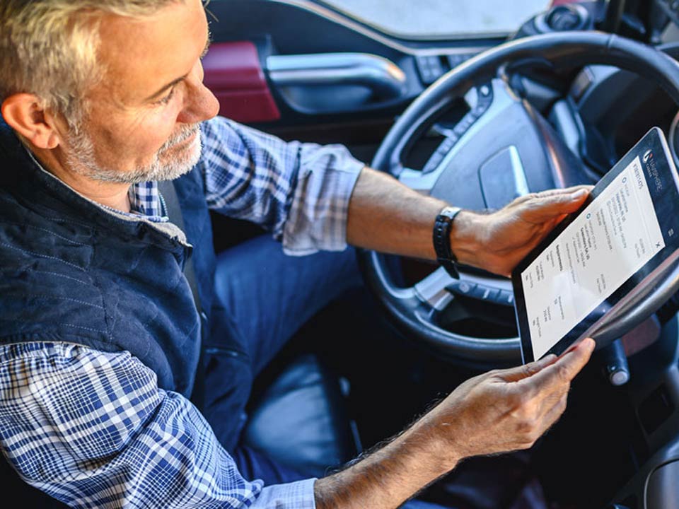 Truck driver on a tablet | Carrier Connectivity