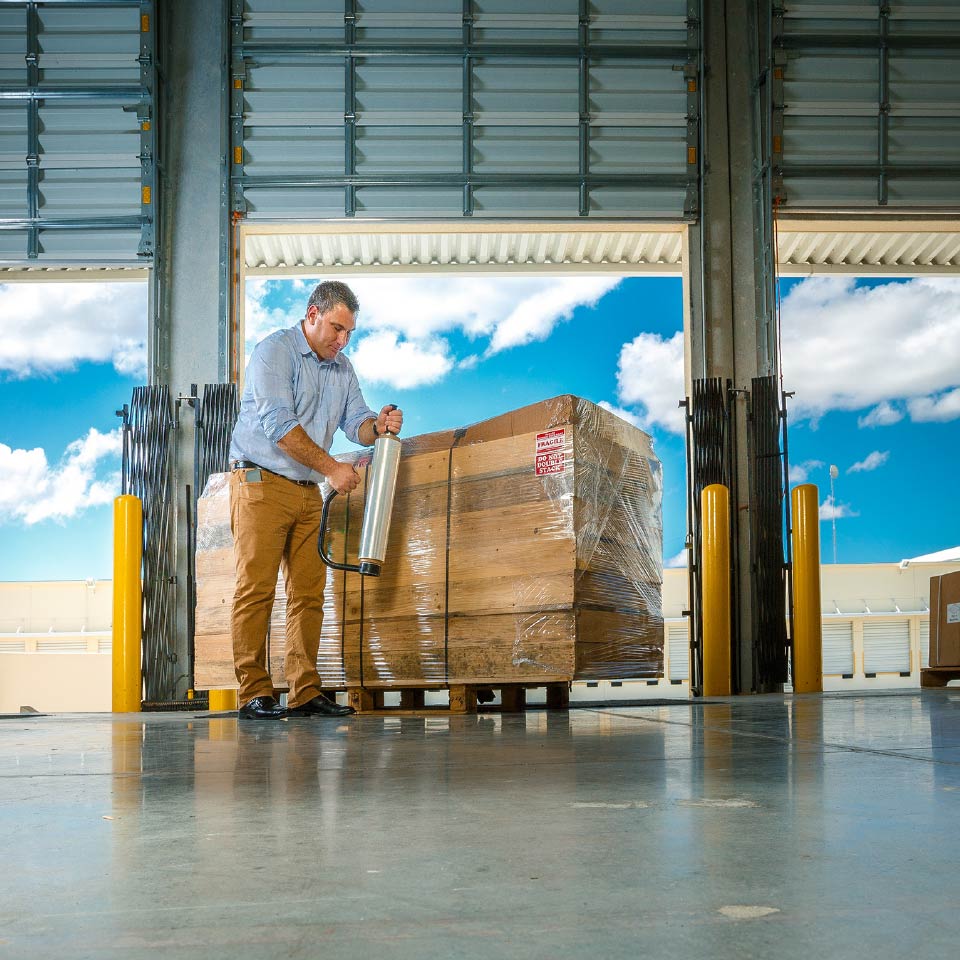 Man wrapping a pallet on a loading dock